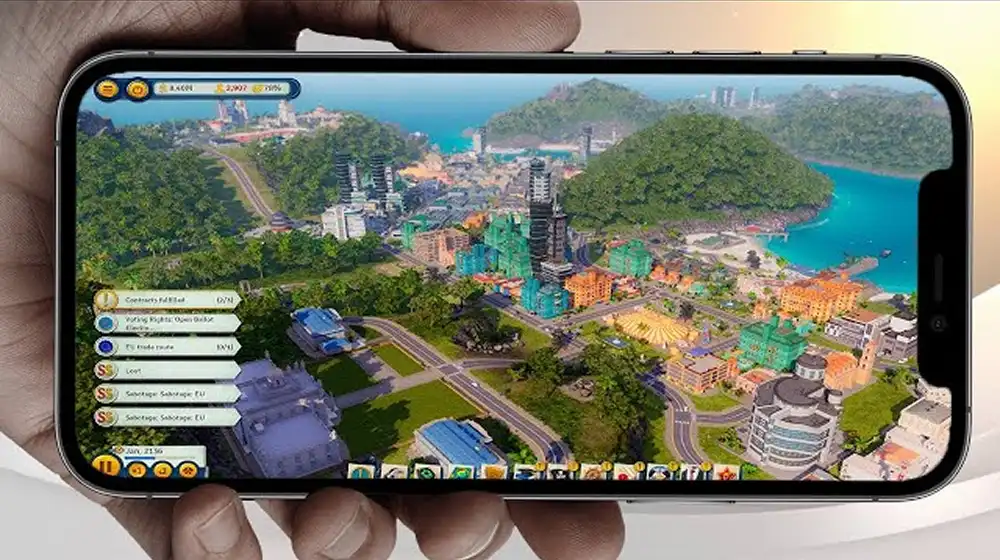 A képen egy okostelefon látható, amelynek képernyőjén egy SimCity-hez hasonló városépítő játék menete látható.